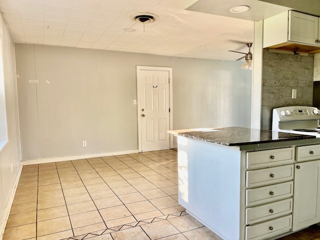 kitchen featuring kitchen peninsula, dark stone countertops, ceiling fan, and light tile patterned floors