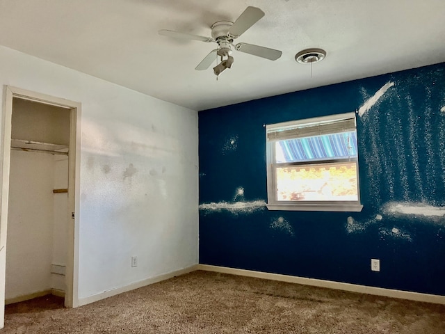 unfurnished bedroom with ceiling fan, a closet, and carpet