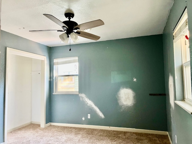 unfurnished bedroom with light colored carpet and ceiling fan