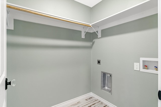 clothes washing area featuring hardwood / wood-style flooring, hookup for a washing machine, and electric dryer hookup