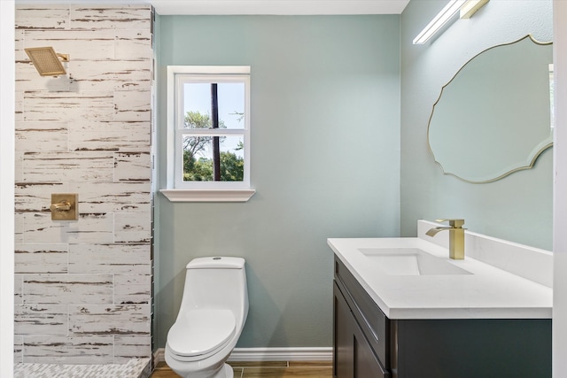 bathroom with wood-type flooring, vanity, and toilet