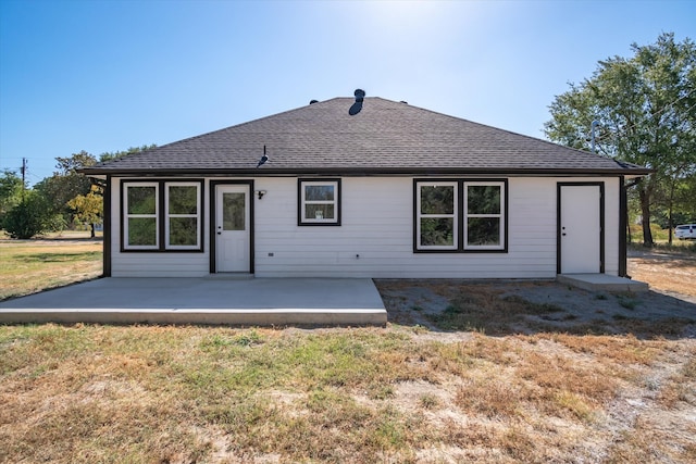 back of property featuring a patio and a yard