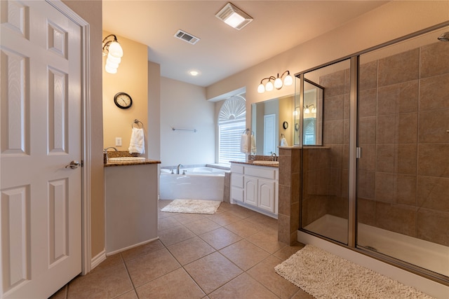 bathroom with tile patterned flooring, vanity, and plus walk in shower