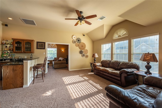 carpeted living room featuring bar, ceiling fan, and lofted ceiling