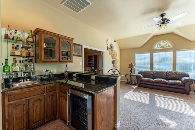 kitchen featuring dark colored carpet, lofted ceiling, sink, and wine cooler