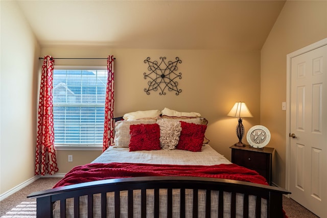 bedroom with carpet flooring and lofted ceiling