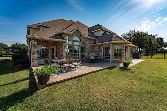 rear view of property featuring a patio area and a lawn