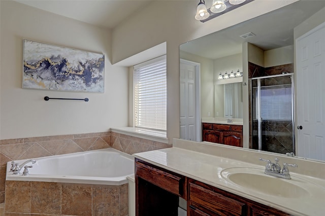 bathroom featuring plus walk in shower and vanity