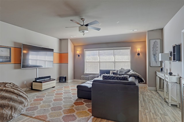 living room featuring light wood-type flooring and ceiling fan