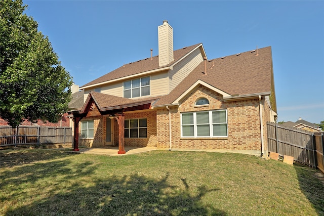 back of house featuring a patio and a lawn