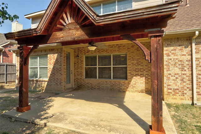 entrance to property with ceiling fan and a patio area