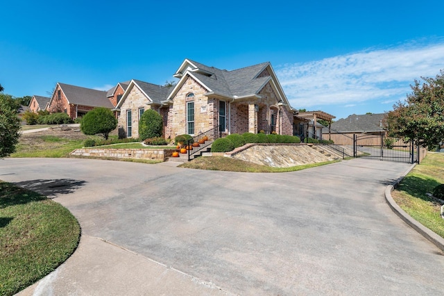 view of front of property featuring brick siding and a gate