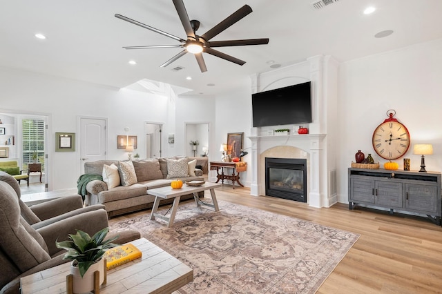 living room with ceiling fan and light hardwood / wood-style floors