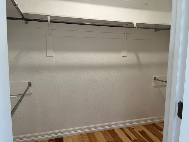 spacious closet featuring hardwood / wood-style flooring