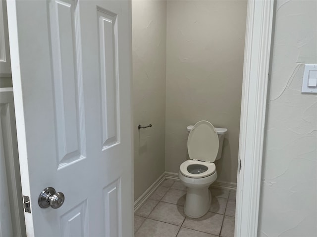 bathroom featuring toilet and tile patterned flooring