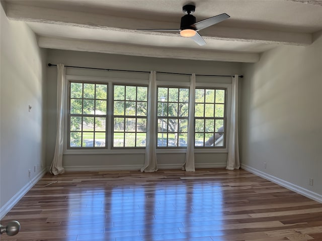 unfurnished room featuring beam ceiling, hardwood / wood-style floors, and ceiling fan