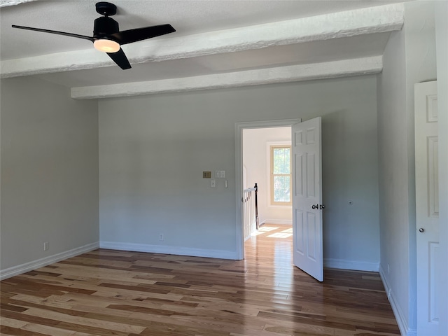 spare room with a textured ceiling, wood-type flooring, and ceiling fan