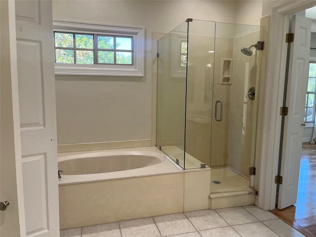 bathroom featuring shower with separate bathtub and hardwood / wood-style floors