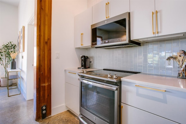 kitchen with backsplash, white cabinets, and appliances with stainless steel finishes