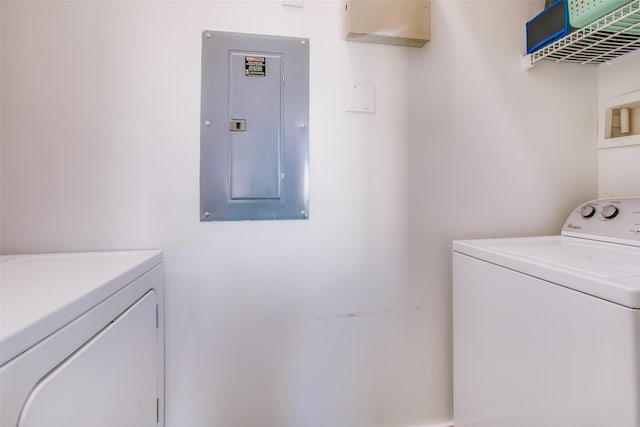 laundry area with independent washer and dryer and electric panel