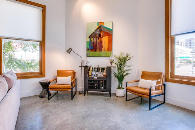 sitting room with plenty of natural light and concrete floors