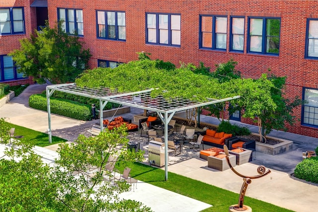 view of property's community featuring outdoor lounge area, a pergola, and a patio area