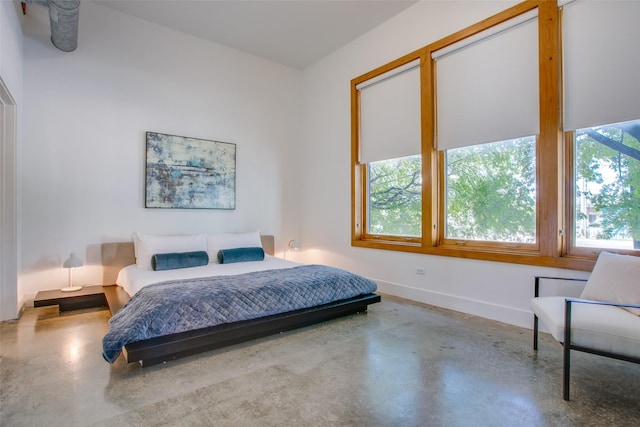 bedroom featuring concrete floors