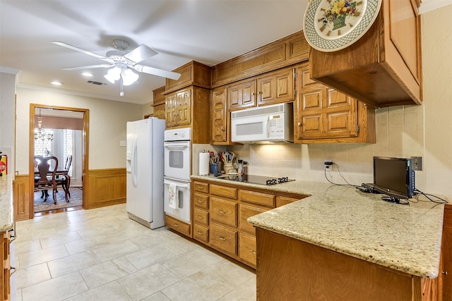 kitchen with ceiling fan, white appliances, light stone counters, decorative backsplash, and ornamental molding