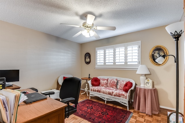 office area featuring ceiling fan, light parquet flooring, and a textured ceiling