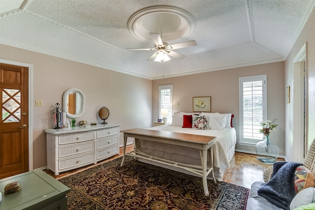 bedroom featuring lofted ceiling, multiple windows, ceiling fan, and hardwood / wood-style floors