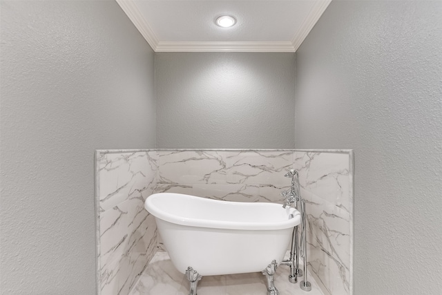 bathroom featuring ornamental molding, a tub, and tile walls