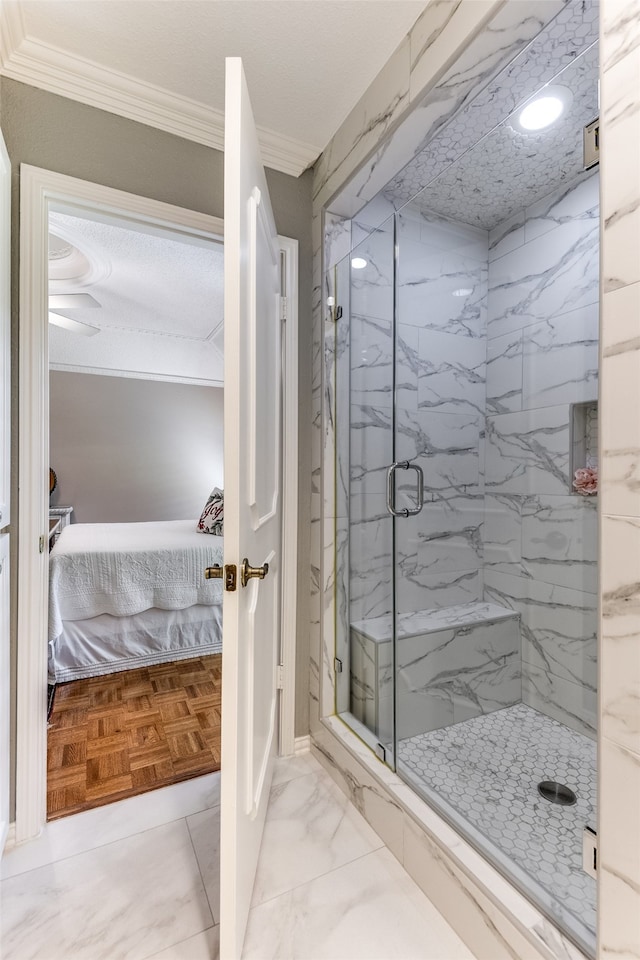 bathroom with an enclosed shower, ornamental molding, and parquet flooring