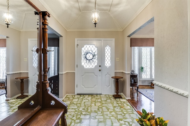 entrance foyer with lofted ceiling, crown molding, and a wealth of natural light