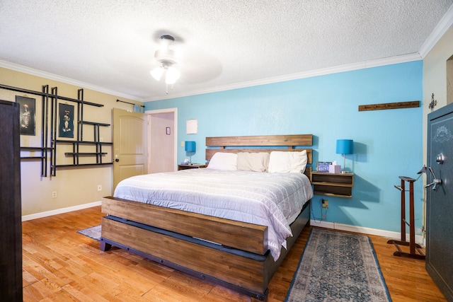 bedroom with ornamental molding, ceiling fan, wood-type flooring, and a textured ceiling