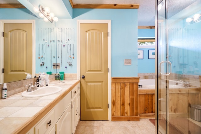 bathroom featuring vanity, plus walk in shower, crown molding, tile patterned flooring, and a textured ceiling