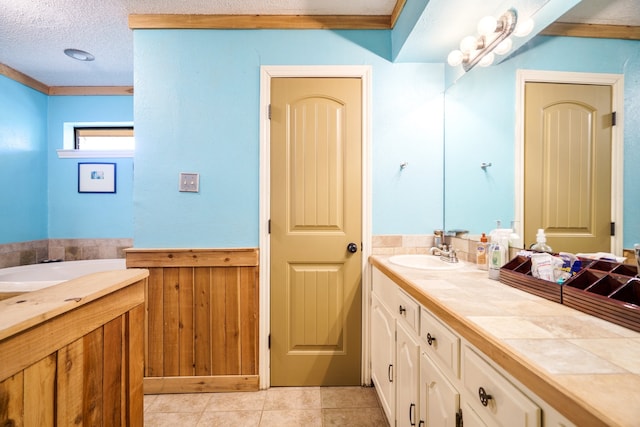 bathroom featuring vanity, a washtub, a textured ceiling, wooden walls, and tile patterned floors