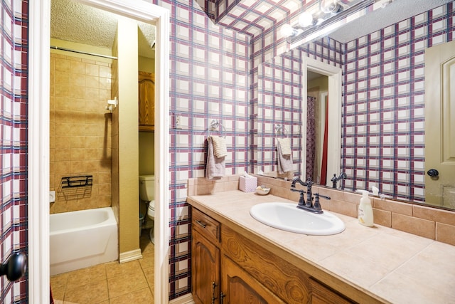 bathroom with a textured ceiling, tile patterned floors, vanity, and toilet