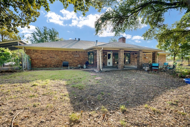 rear view of property featuring a patio area