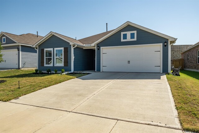 single story home featuring a garage and a front yard