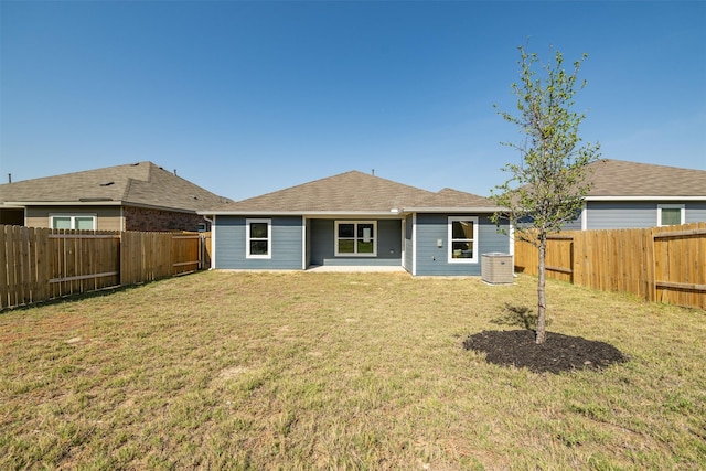 rear view of property featuring a lawn