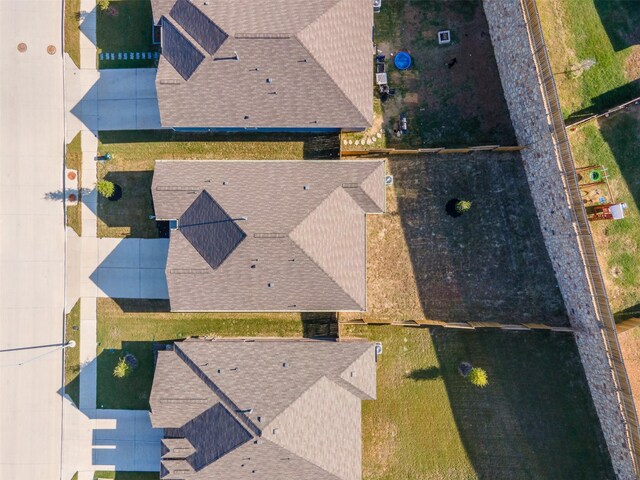 ranch-style home with a garage and a front lawn