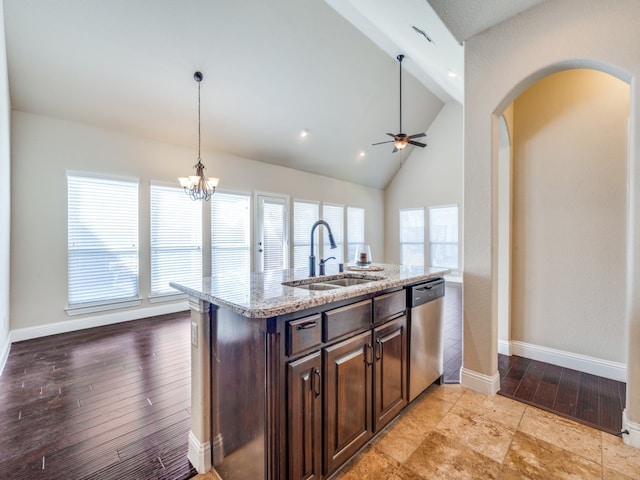 kitchen featuring light hardwood / wood-style floors, stainless steel dishwasher, sink, and light stone counters