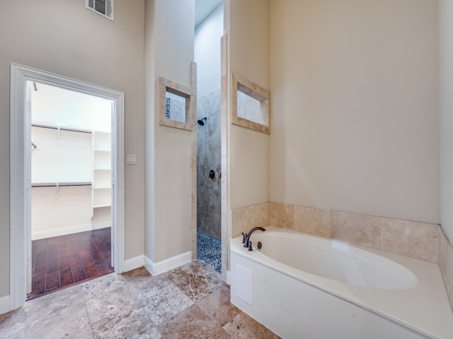 bathroom with hardwood / wood-style flooring and separate shower and tub