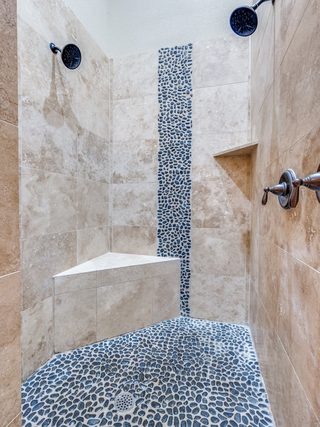 bathroom with a tile shower