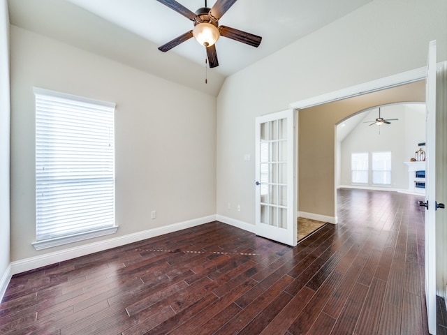 unfurnished room featuring lofted ceiling, ceiling fan, and dark hardwood / wood-style flooring