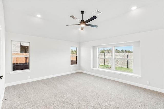 carpeted spare room with ceiling fan