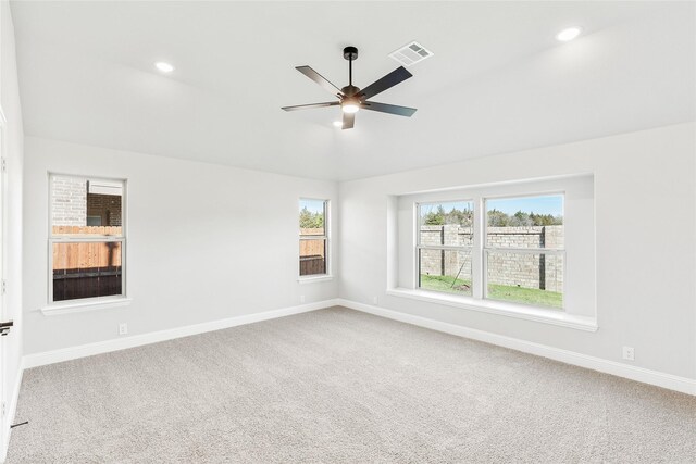 unfurnished room featuring vaulted ceiling, carpet flooring, and ceiling fan