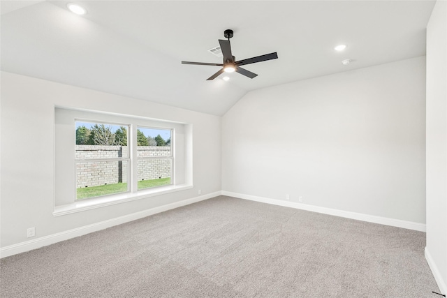 unfurnished room with ceiling fan, lofted ceiling, and carpet flooring