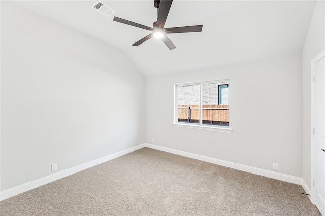 carpeted empty room featuring lofted ceiling and ceiling fan