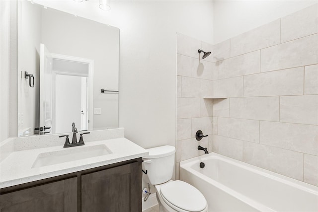 full bathroom with toilet, tiled shower / bath, and vanity